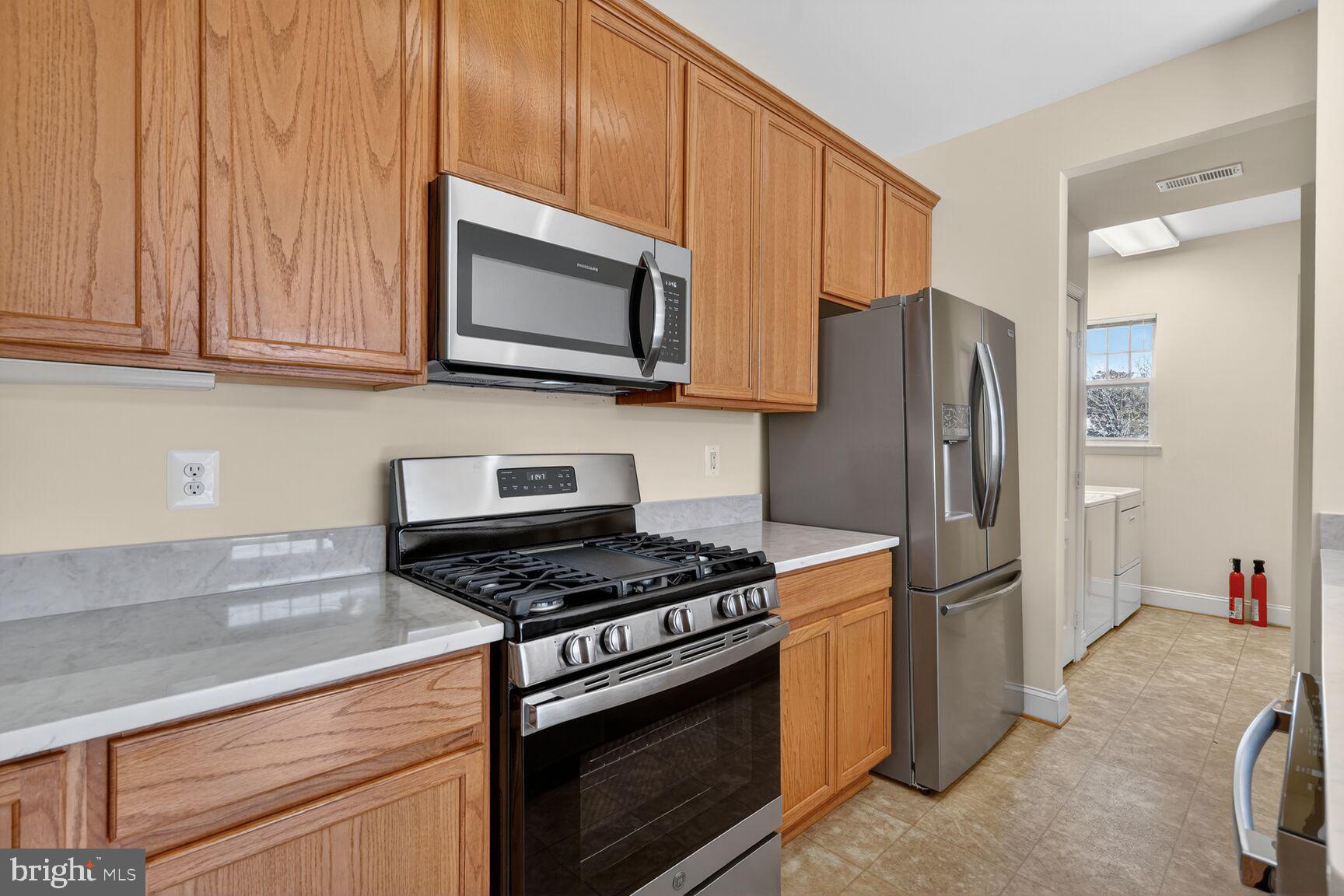 13210 Rabbit Chase Road Laurel, MD 20707 - Photo 10 of 40 a kitchen with stainless steel appliances granite countertop a refrigerator stove and microwave