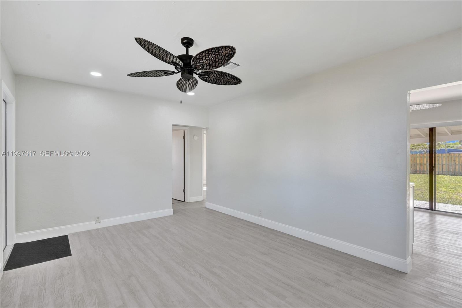 136 Miami Gardens Road West Park, FL 33023 - Photo 14 of 44 wooden floor in an empty room with a window