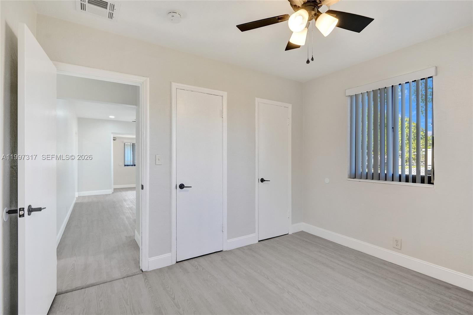 136 Miami Gardens Road West Park, FL 33023 - Photo 23 of 44 wooden floor in an empty room with a window