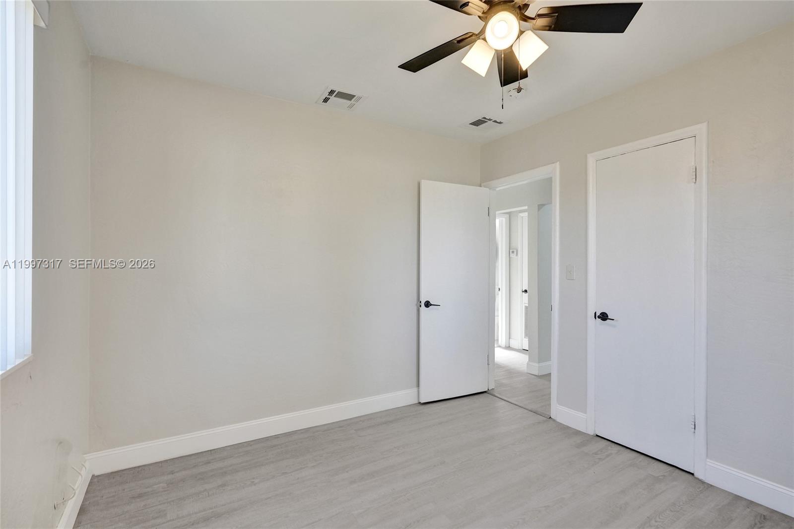 136 Miami Gardens Road West Park, FL 33023 - Photo 24 of 44 a view of an empty room and chandelier fan
