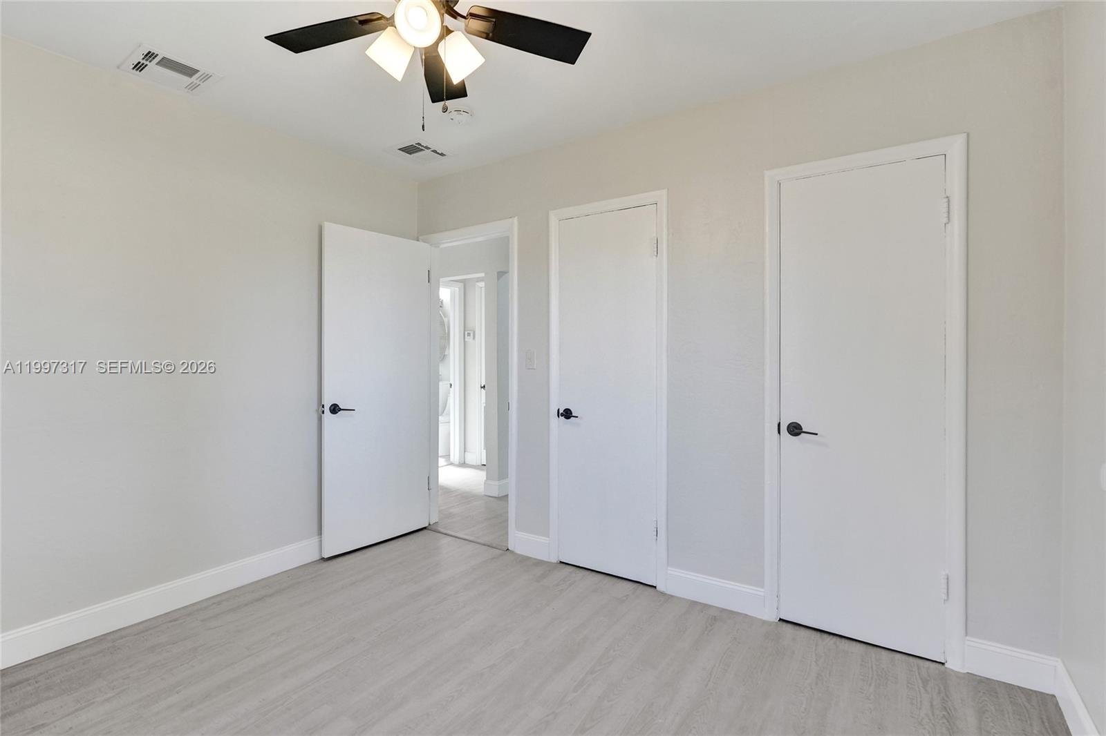 136 Miami Gardens Road West Park, FL 33023 - Photo 25 of 44 a view of an empty room and chandelier fan