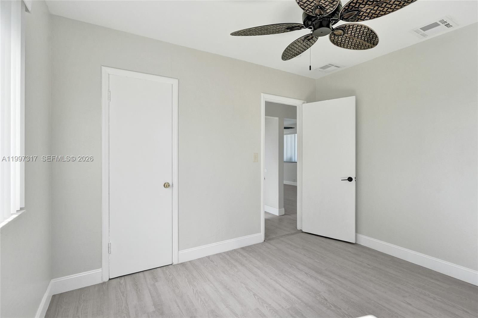 136 Miami Gardens Road West Park, FL 33023 - Photo 32 of 44 an empty room with wooden floor