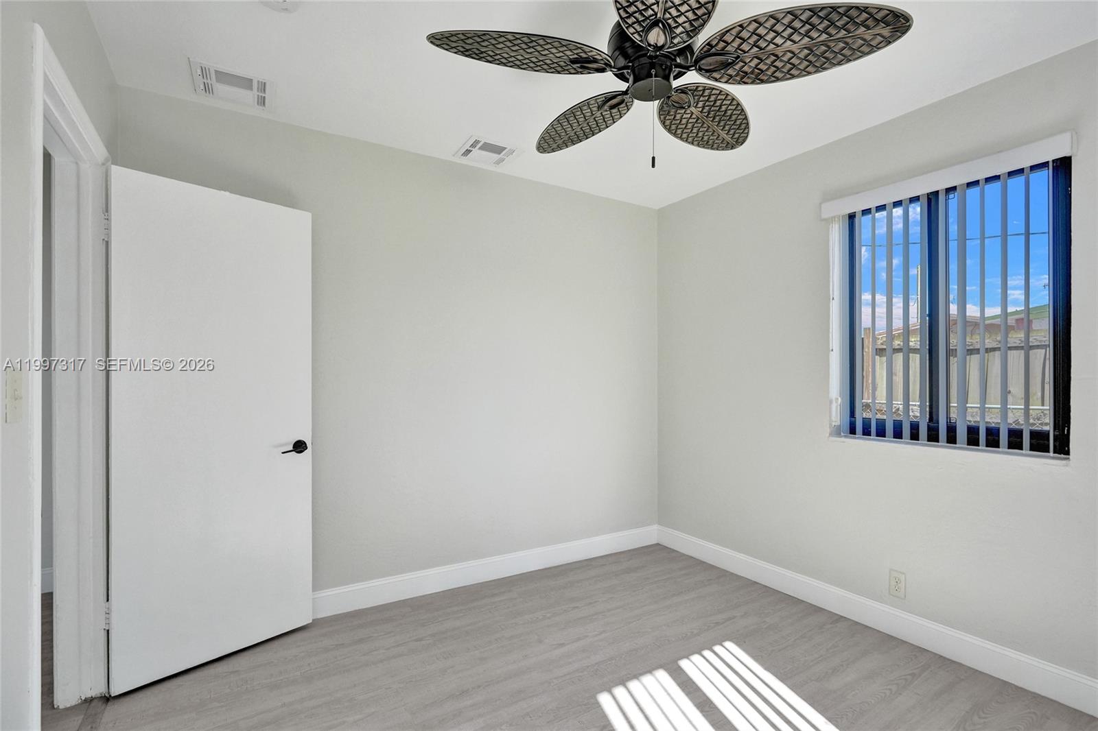 136 Miami Gardens Road West Park, FL 33023 - Photo 33 of 44 a view of an empty room with a window