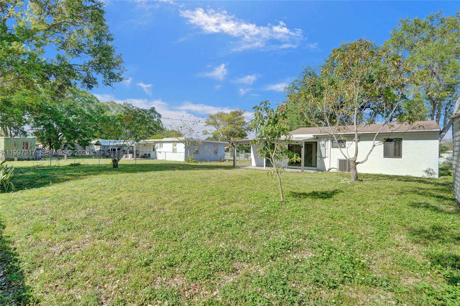 136 Miami Gardens Road West Park, FL 33023 - Photo 38 of 44 a front view of a house with a yard