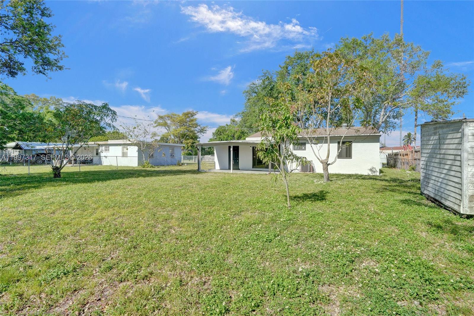 136 Miami Gardens Road West Park, FL 33023 - Photo 39 of 44 a front view of a house with garden