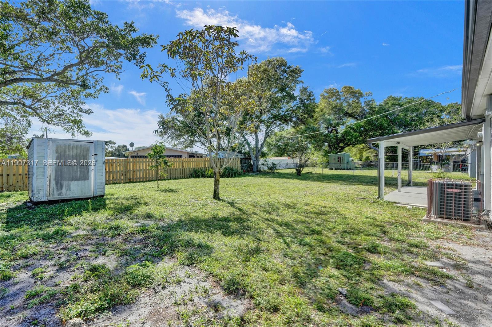 136 Miami Gardens Road West Park, FL 33023 - Photo 42 of 44 a view of a yard with a house