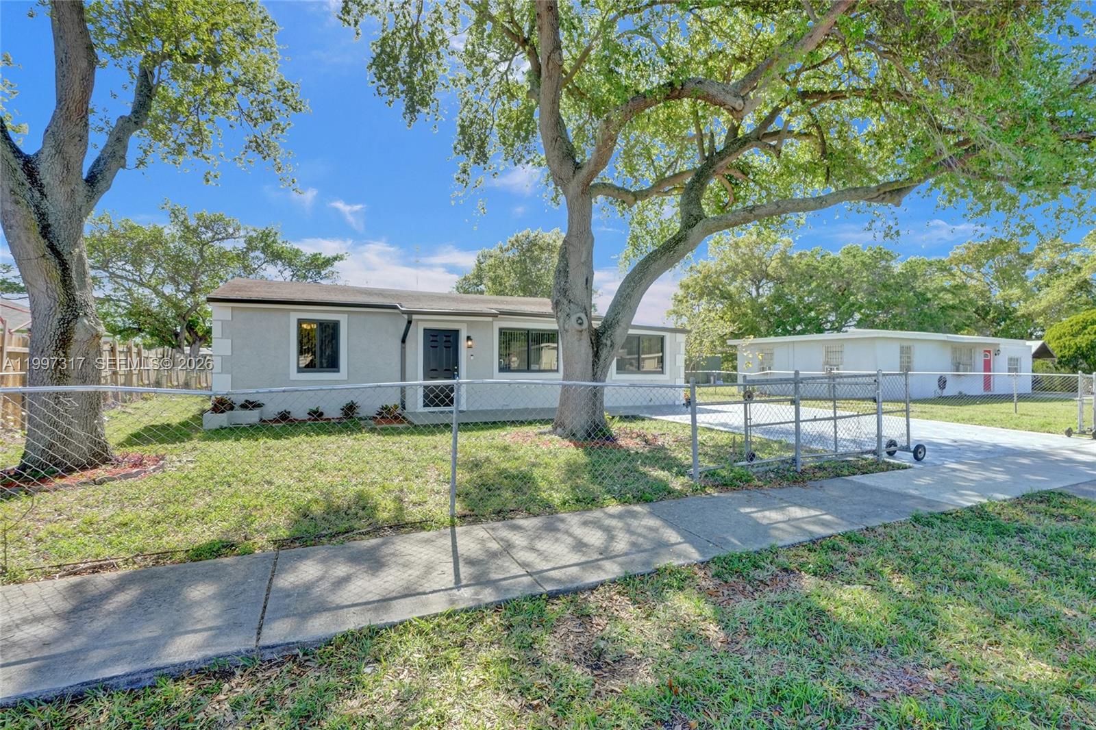 136 Miami Gardens Road West Park, FL 33023 - Photo 44 of 44 a view of a house with a yard