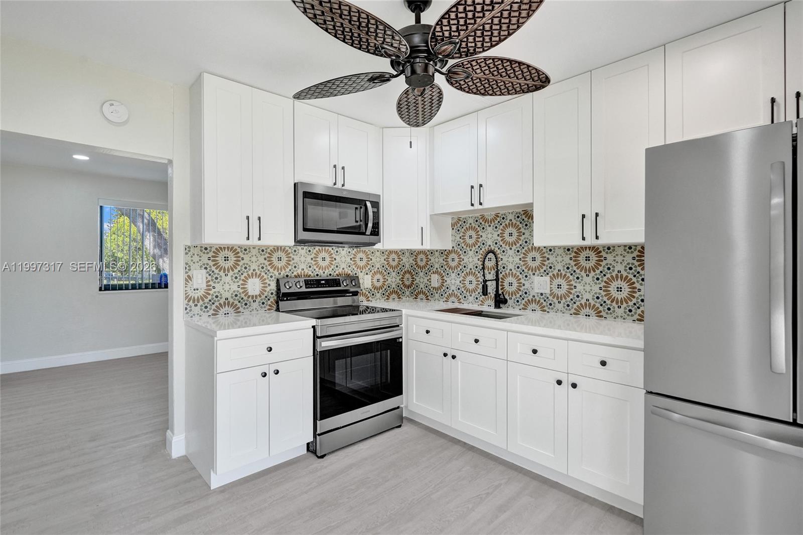 136 Miami Gardens Road West Park, FL 33023 - Photo 6 of 44 a kitchen with stainless steel appliances a refrigerator sink and cabinets