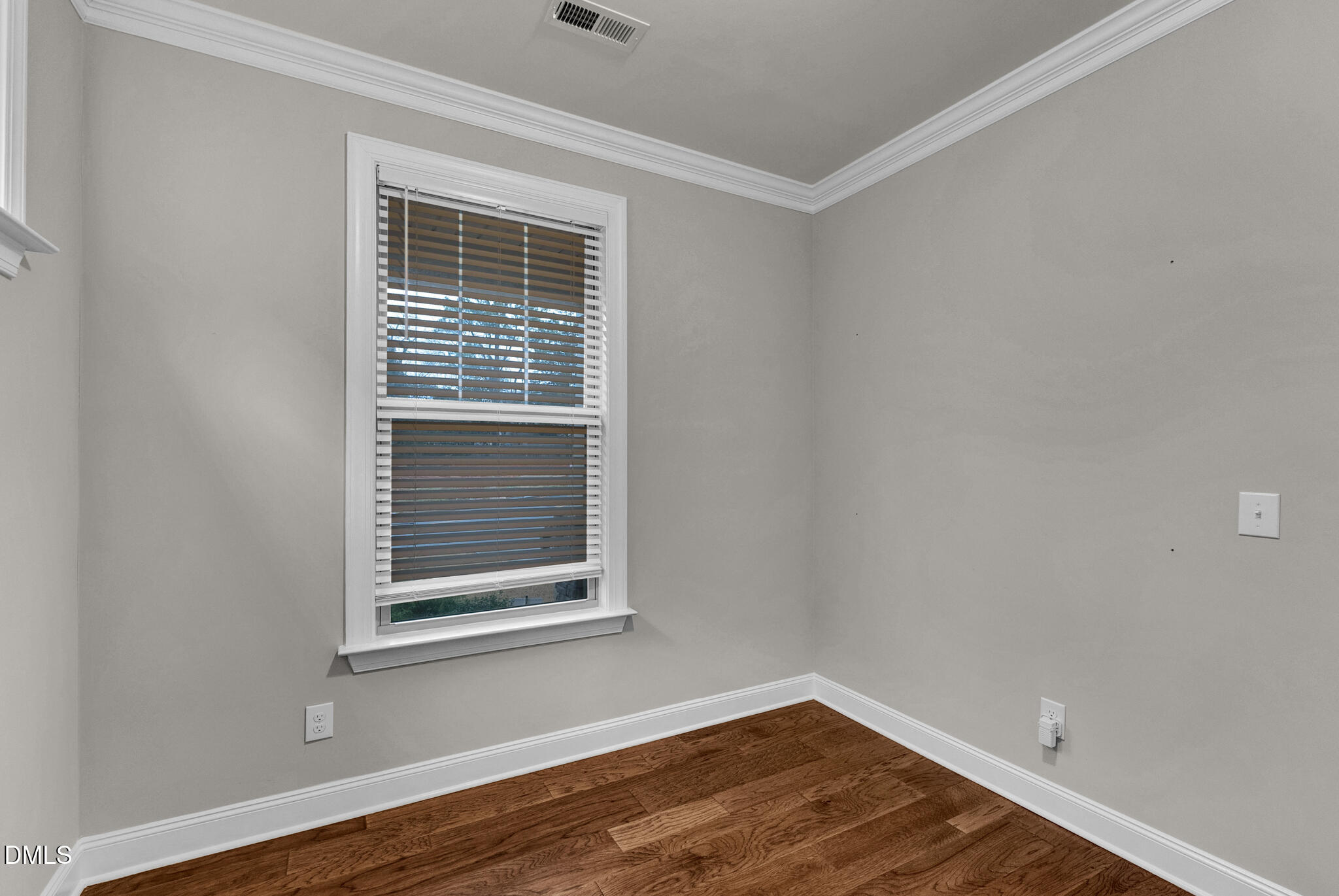 928 Barringer Drive Raleigh, NC 27606 - Photo 29 of 40 a view of an empty room with wooden floor and a window