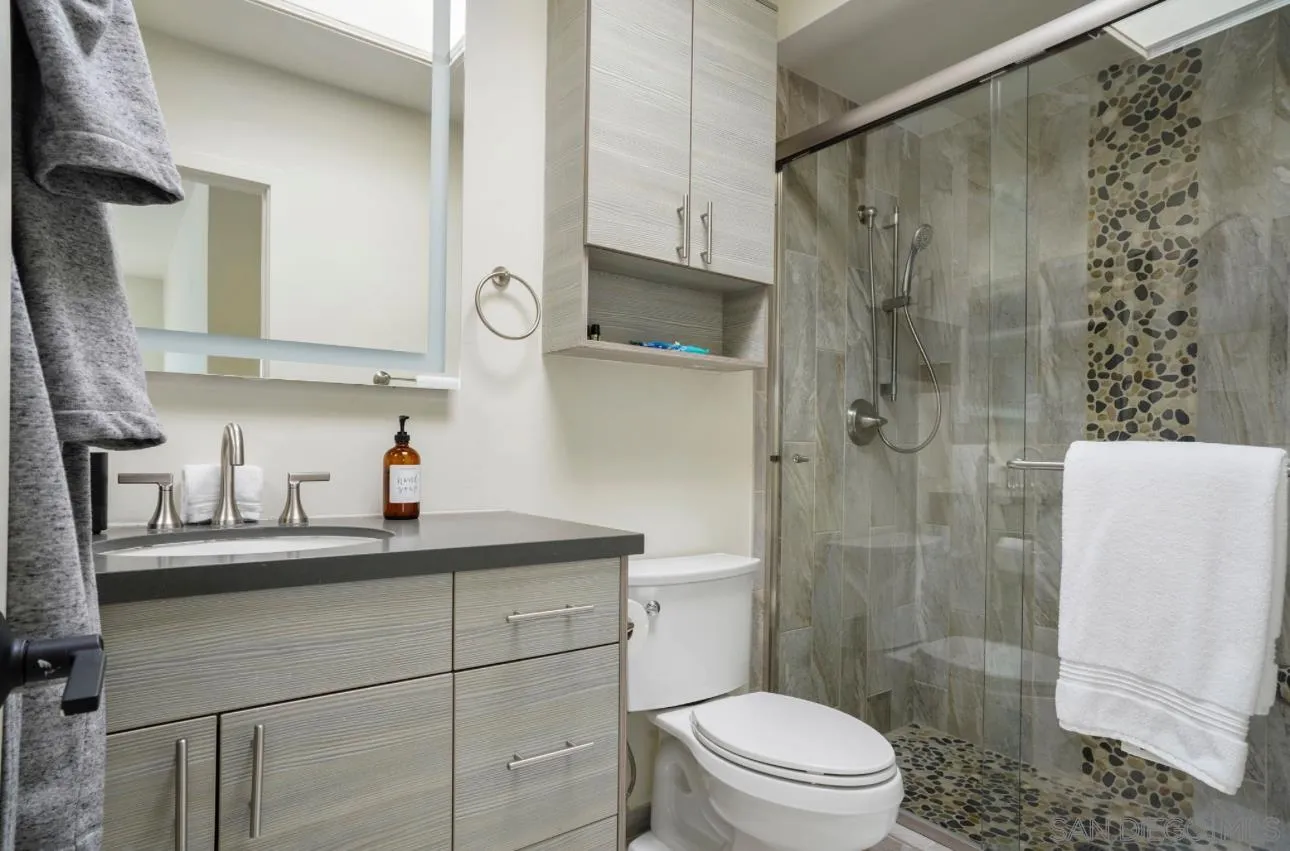 2820 Bayside Walk, Unit 2 San Diego, CA 92109 - Photo 14 of 16 a bathroom with a sink a toilet and shower