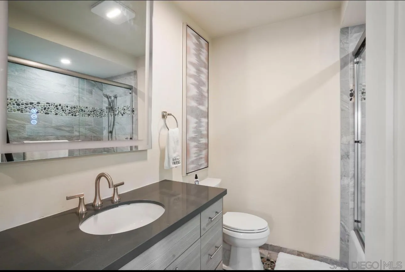 2820 Bayside Walk, Unit 2 San Diego, CA 92109 - Photo 15 of 16 a bathroom with a sink a toilet and a mirror