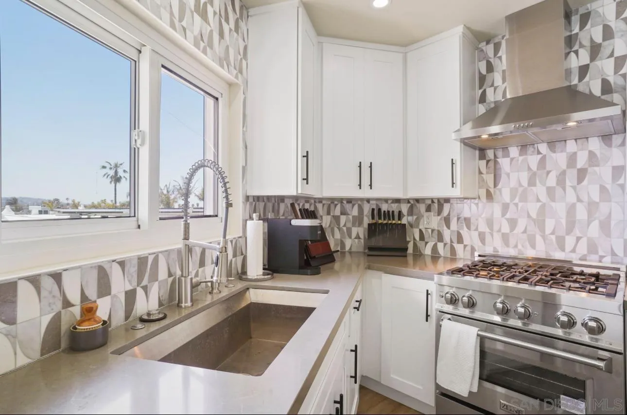 2820 Bayside Walk, Unit 2 San Diego, CA 92109 - Photo 8 of 16 a kitchen with a stove and a white cabinets