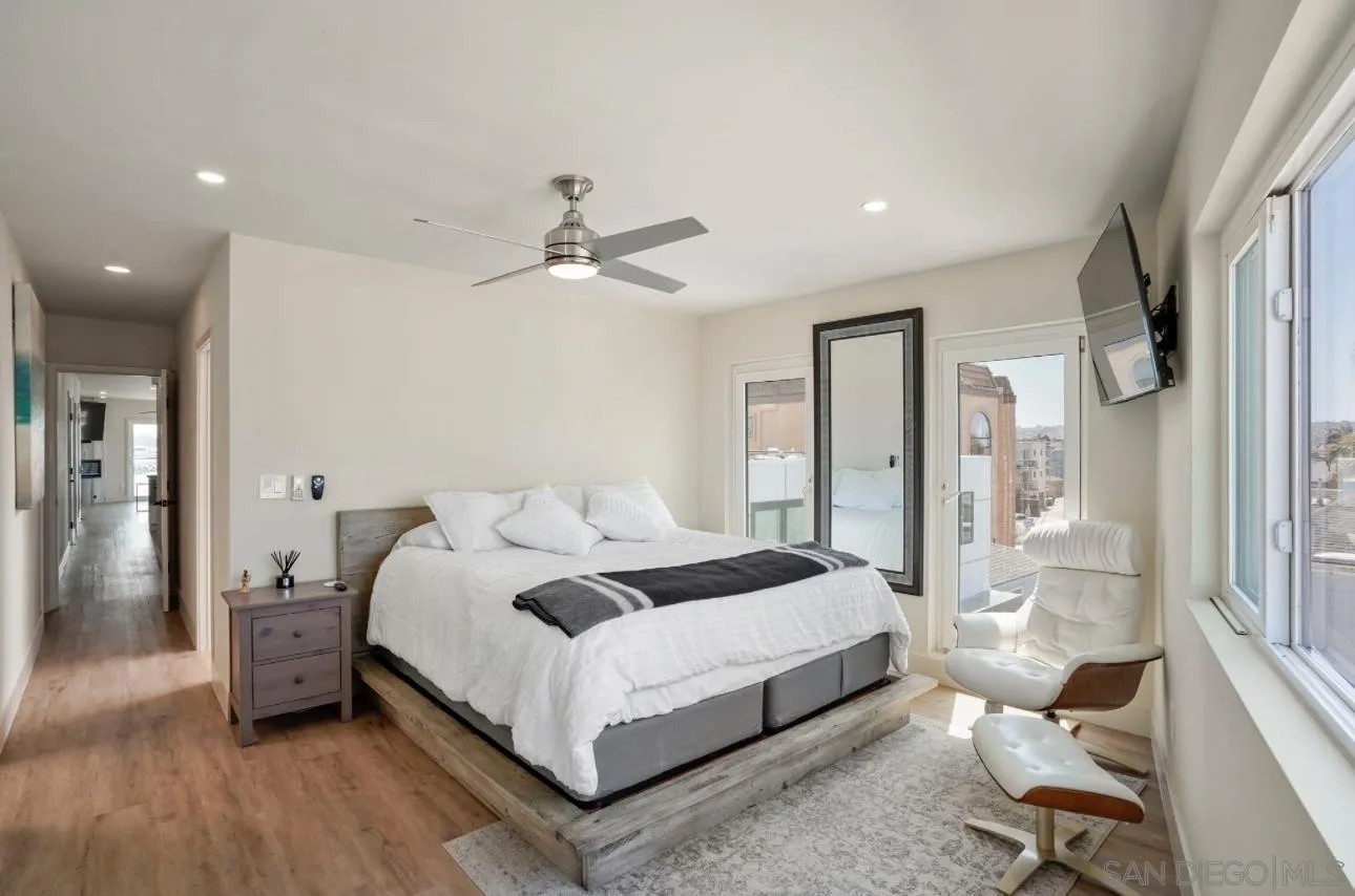 2820 Bayside Walk, Unit 2 San Diego, CA 92109 - Photo 10 of 16 a bedroom with a bed and a chandelier