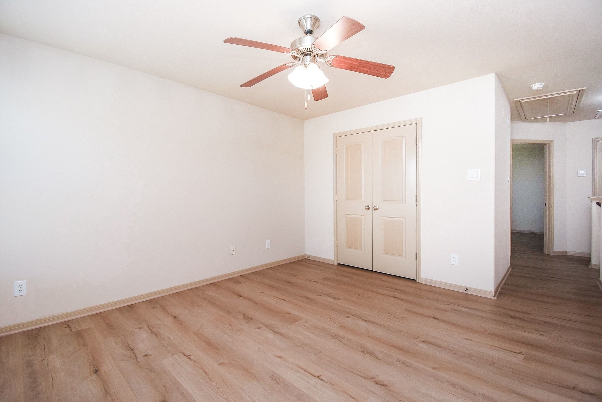 2106 Harmon Crest Court Spring, TX 77373 - Photo 27 of 37 an empty room with wooden floor and ceiling fan