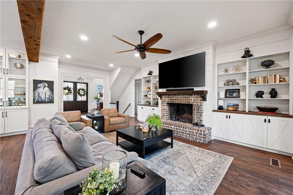 7093 Vaughn Road Woodstock, GA 30188 - Photo 14 of 86 a living room with furniture a flat screen tv and a fireplace