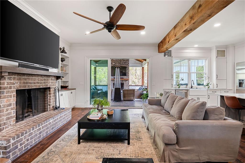 7093 Vaughn Road Woodstock, GA 30188 - Photo 21 of 86 a living room with furniture a fireplace and a flat screen tv