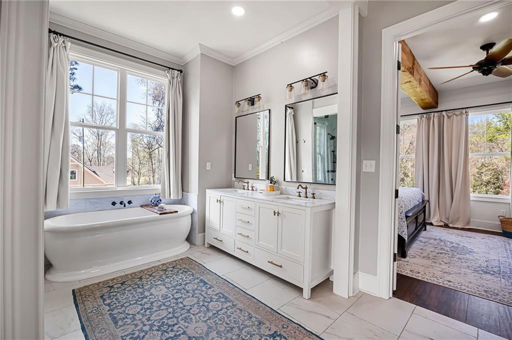 7093 Vaughn Road Woodstock, GA 30188 - Photo 39 of 86 a bathroom with a tub sink and mirror