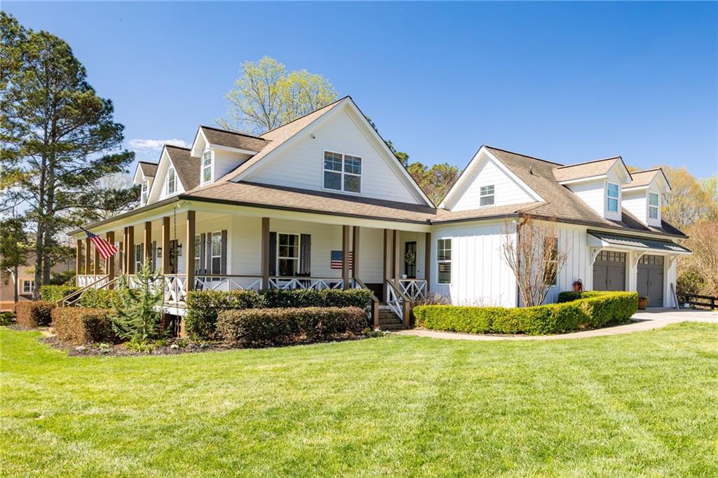 7093 Vaughn Road Woodstock, GA 30188 - Photo 4 of 86 a front view of a house with a garden