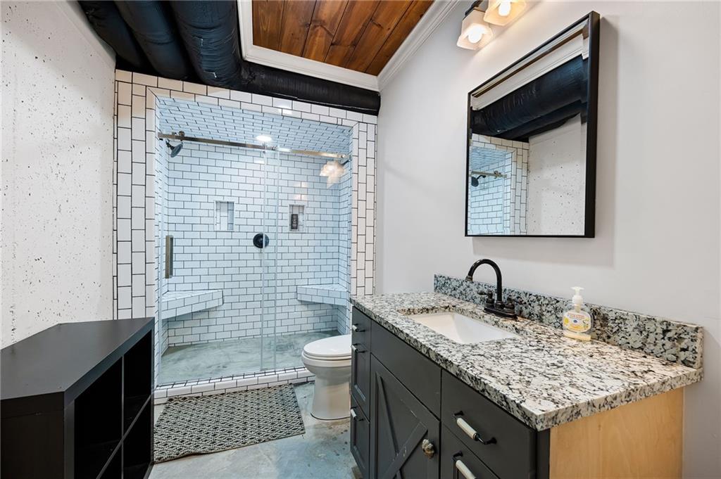 7093 Vaughn Road Woodstock, GA 30188 - Photo 48 of 86 a bathroom with a granite countertop sink toilet and shower