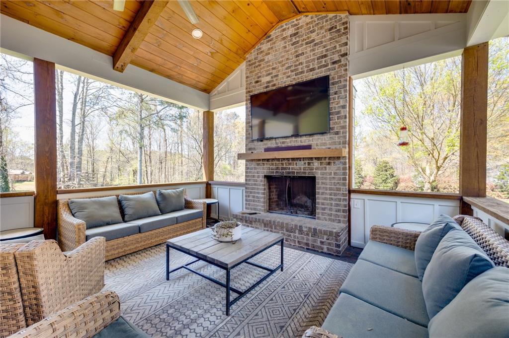 7093 Vaughn Road Woodstock, GA 30188 - Photo 62 of 86 a living room with furniture a flat screen tv and a fireplace