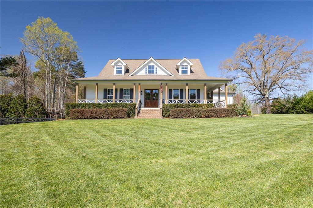 7093 Vaughn Road Woodstock, GA 30188 - Photo 10 of 86 a front view of a house with a garden