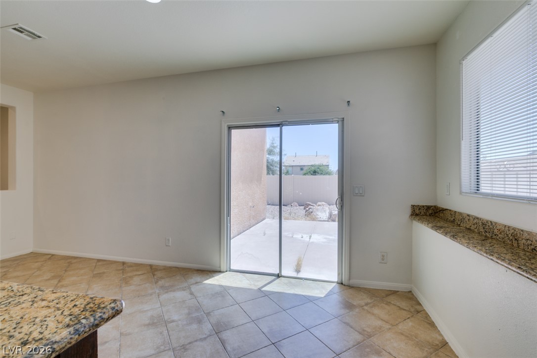 5150 Riverside Run Court North Las Vegas, NV 89081 - Photo 26 of 50 A well-lit interior space featuring tile flooring and convenient sliding doors leading to a private outdoor area.
