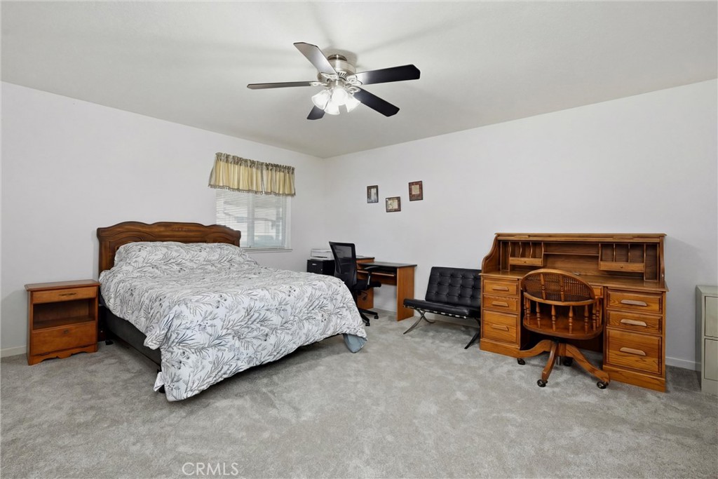18685 Oak Grove Road Hidden Valley Lake, CA 95467 - Photo 9 of 52 a bedroom with a bed and a chandelier