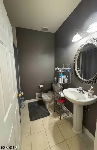 a bed sitting in a room next to a lamp