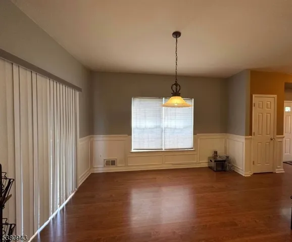 a kitchen with stainless steel appliances granite countertop a sink and a white cabinets
