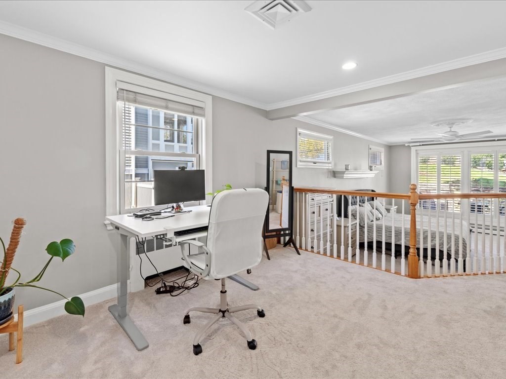 39 Broad Meadow Road Needham, MA 02492 - Photo 20 of 36 a living room with furniture a chandelier and a window