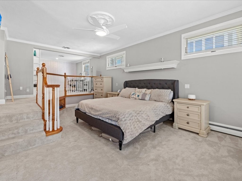 39 Broad Meadow Road Needham, MA 02492 - Photo 23 of 36 a bedroom with a bed and a chandelier