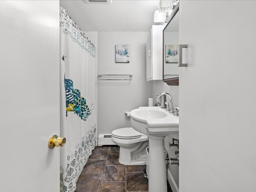 39 Broad Meadow Road Needham, MA 02492 - Photo 27 of 36 a white toilet sitting next to a bathroom sink