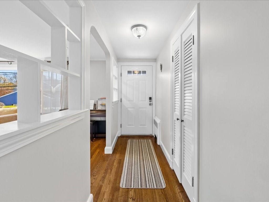 39 Broad Meadow Road Needham, MA 02492 - Photo 3 of 36 a view of a hallway with wooden floor and staircase
