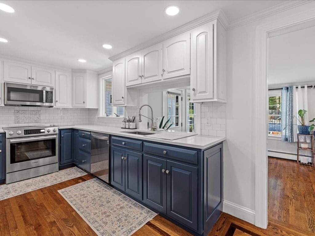 39 Broad Meadow Road Needham, MA 02492 - Photo 6 of 36 a kitchen with stainless steel appliances granite countertop a sink stove and microwave