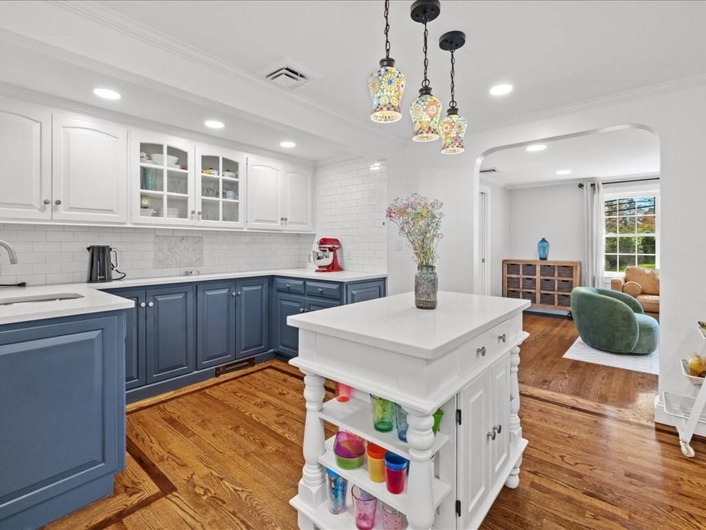 39 Broad Meadow Road Needham, MA 02492 - Photo 8 of 36 a large kitchen with kitchen island a stove a sink a dining table and chairs