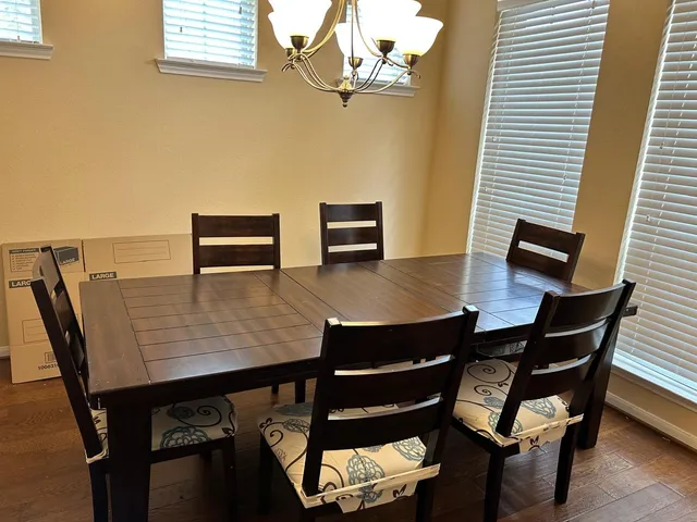 a view of a dining room with furniture and wooden floor