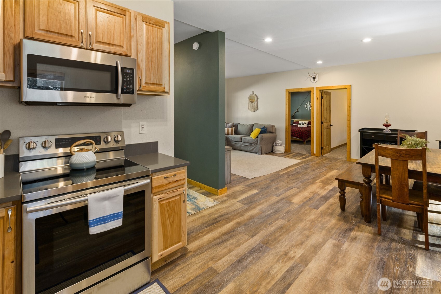 401 Whyworry Lane Ronald, WA 98940 - Photo 6 of 23 a kitchen with stainless steel appliances kitchen island granite countertop a stove top oven a sink dishwasher a dining table and chairs with wooden floor