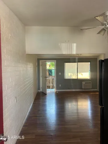 a view of a room with wooden floor and a window