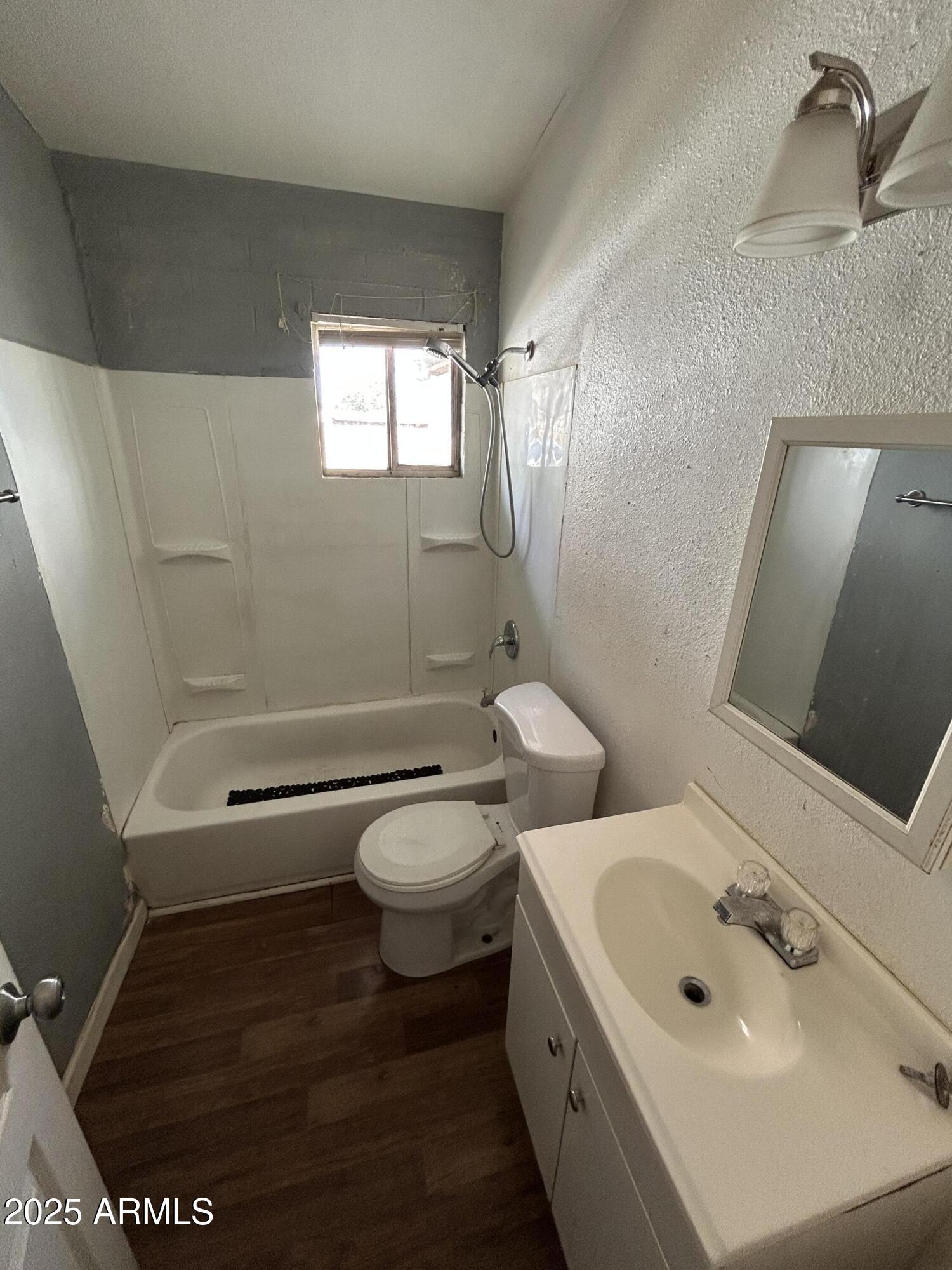 1801 West Carol Avenue, Unit 3 Phoenix, AZ 85021 - Photo 9 of 10 a bathroom with a toilet sink and mirror