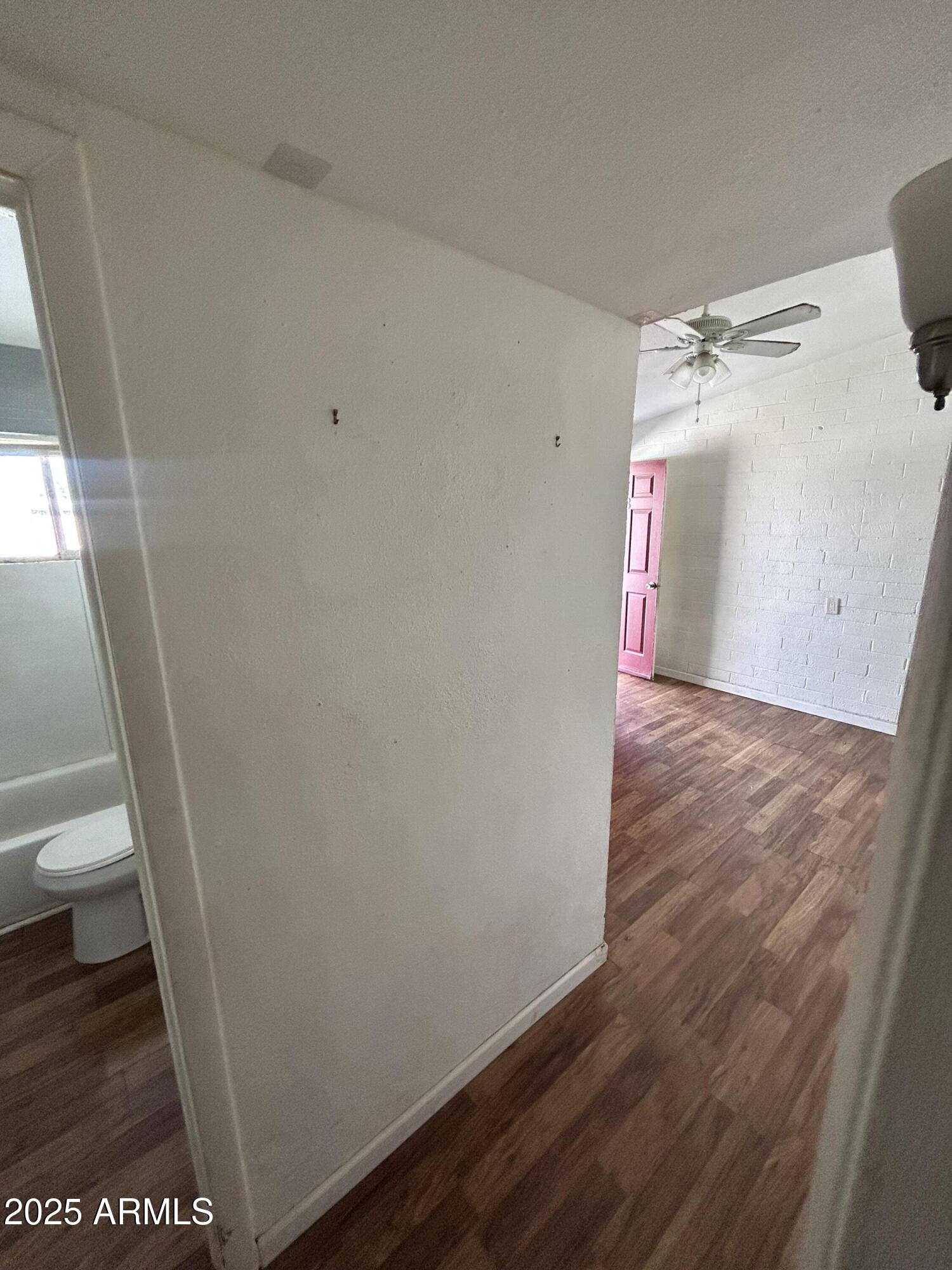 1801 West Carol Avenue, Unit 3 Phoenix, AZ 85021 - Photo 10 of 10 a view of a room with wooden floor and white walls