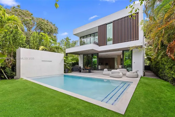 a view of a house with patio and a yard