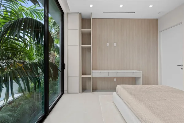 a bedroom with a bed and a mirror