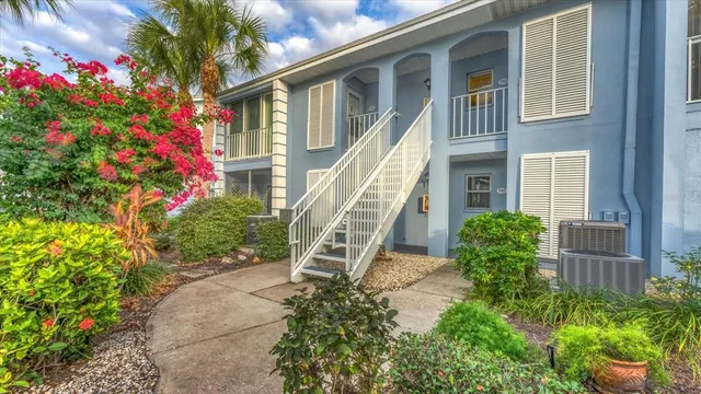 a front view of a house with a yard and potted plants