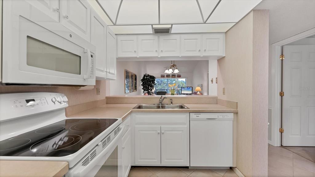 450 Cerromar Road, Unit 282 Venice, FL 34293 - Photo 11 of 44 a kitchen with stainless steel appliances granite countertop a sink and a stove