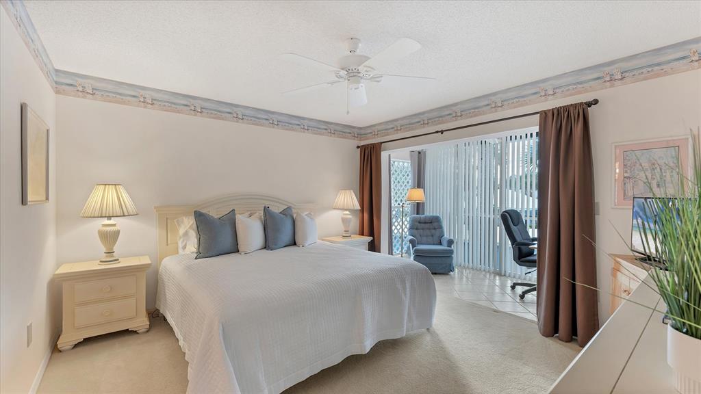 450 Cerromar Road, Unit 282 Venice, FL 34293 - Photo 12 of 44 a bedroom with a large bed and a chandelier