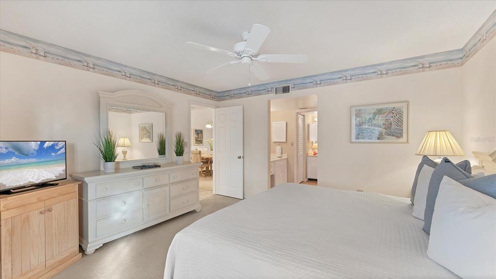 450 Cerromar Road, Unit 282 Venice, FL 34293 - Photo 14 of 44 a large white room with a large mirror and vanity