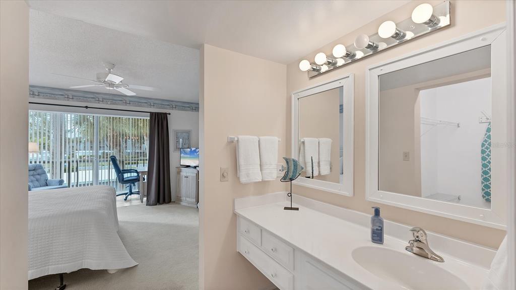 450 Cerromar Road, Unit 282 Venice, FL 34293 - Photo 18 of 44 a spacious bathroom with a double vanity sink and a mirror