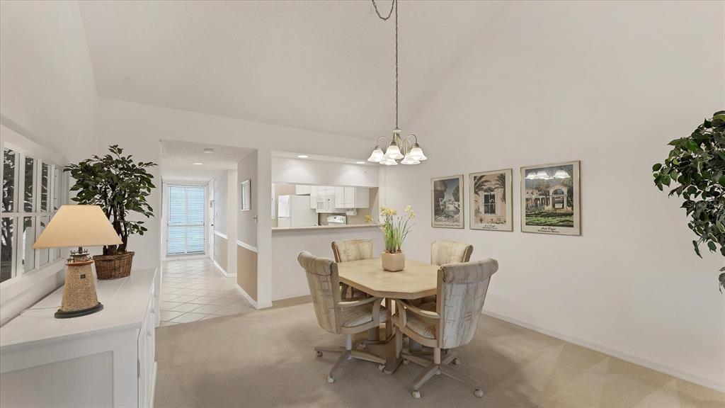 450 Cerromar Road, Unit 282 Venice, FL 34293 - Photo 6 of 44 a view of a dining room with furniture and chandelier