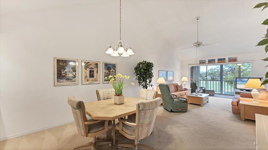 450 Cerromar Road, Unit 282 Venice, FL 34293 - Photo 7 of 44 a dining room with furniture a chandelier and window