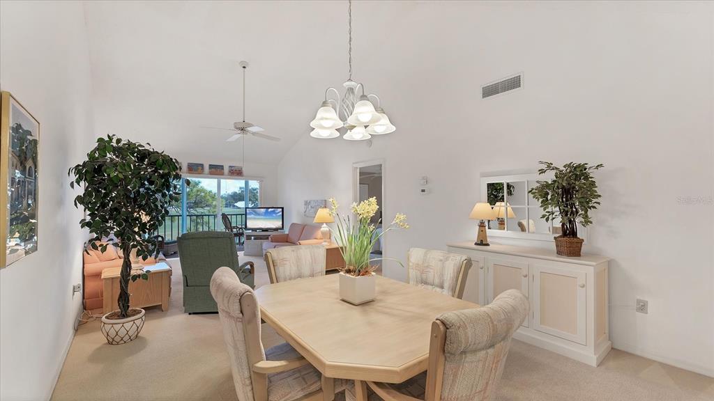 450 Cerromar Road, Unit 282 Venice, FL 34293 - Photo 8 of 44 a view of a dining room with furniture and chandelier